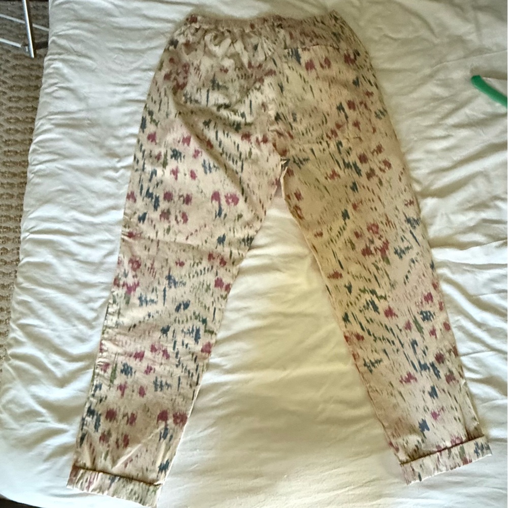 Humanoid nylon pants cream with blue, green and pink paint speckles.